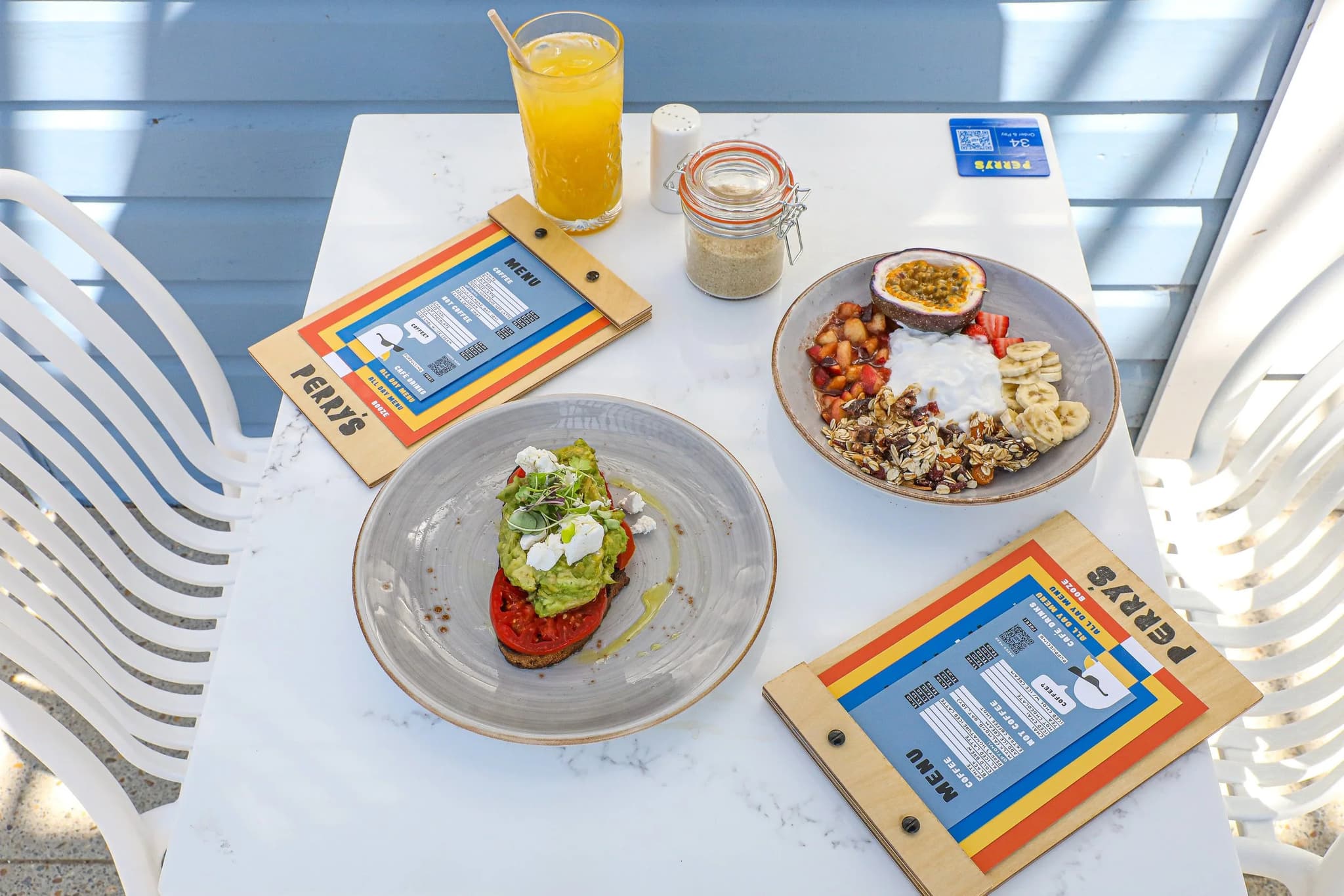 Smashed avocado toast, a granola bowl and orange juice