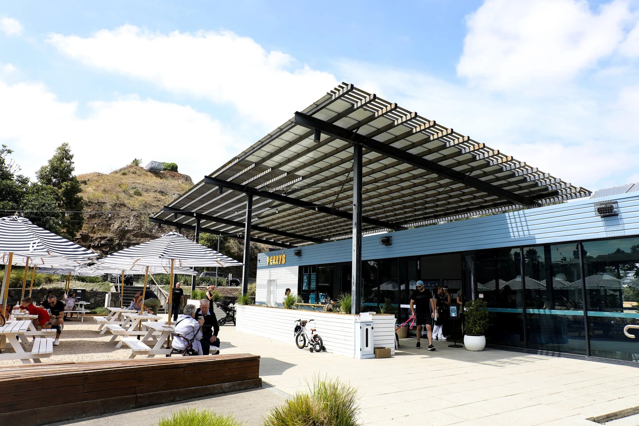 Outdoor tables and umbrellas beside Perry's